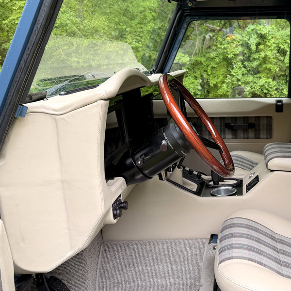 Side view of the dash, steering column and wood-rim wheel from the driver door