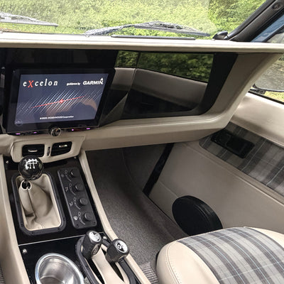 Dash Conversion Kit installed in a left-hand-drive Land Rover Defender: Kenwood Excelon head unit, climate controls and center console