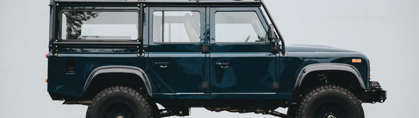 A blue Blackbridge Mark X Defender 110 from the side